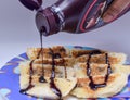 Pouring and garnishing hot choco lava bread with chocolate syrup