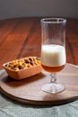 Pouring of German wheat beer is glass and bowl with party mix nuts Royalty Free Stock Photo