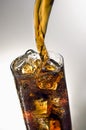 Pouring a glass of Coca-cola with ice cubes Royalty Free Stock Photo