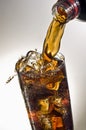 Pouring a glass of Coca-cola with ice cubes Royalty Free Stock Photo