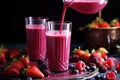 pouring a glass of cold mixed berry smoothie
