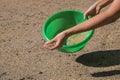 Pouring grass seeds from the packaging into the bowl. Lawn installation