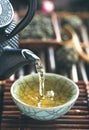 Pouring green tea vertical closeup