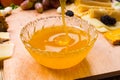 Pouring healthy golden honey