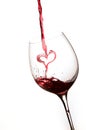 Pouring a heart of red wine in a glass Royalty Free Stock Photo