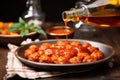 pouring homemade tomato sauce over meatballs