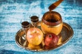 Pouring honey on apple and pomegranate with honey symbols of Jewish New Year - Rosh Hashanah Royalty Free Stock Photo