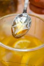 pouring honey in a cup of tea Royalty Free Stock Photo
