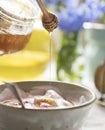 Pouring honey into a dish bowl