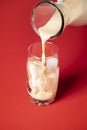 Pouring horchata drink in a glass with ice. Mexican summer drink Royalty Free Stock Photo