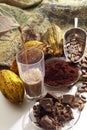 Pouring hot chocolate in a glass, cocoa beans, cocoa powder and chocolate Royalty Free Stock Photo