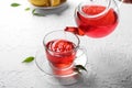 Pouring hot red tea into glass cup on table Royalty Free Stock Photo