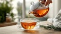 Pouring hot tea into a clear glass cup Royalty Free Stock Photo