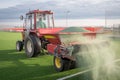 Pouring infill on artificial grass Royalty Free Stock Photo