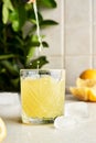 Pouring Italian typical digestive limoncello in a glass with kitchen background