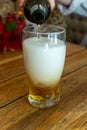 Pouring of light lager beer in glass Royalty Free Stock Photo