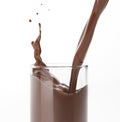 Pouring liquid chocolate in a glass with splash. on white Royalty Free Stock Photo