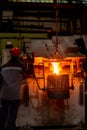 Pouring liquid metal from the furnace into the vat at metallurgical production. Metal part factory, foundry cast, heavy industry