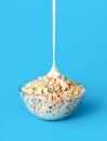Pouring mayo over oliveir salad, minimalist on a blue background Royalty Free Stock Photo