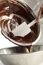 Pouring melted chocolate into a metal bowl Royalty Free Stock Photo