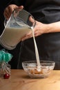 Pouring milk, blueberries, freezing in motion. Cooking breakfast cereals, granules, breakfast cereals, cereals, berries of Royalty Free Stock Photo