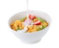 Pouring milk into bowl of corn flakes with fruit Royalty Free Stock Photo