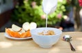 Pouring milk into bowl of corn flakes Royalty Free Stock Photo