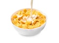Pouring milk into bowl with corn flakes on white background Royalty Free Stock Photo