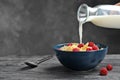 Pouring milk into bowl with cornflakes Royalty Free Stock Photo