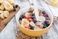 Pouring Milk in a bowl with Cornflakes and Fruits