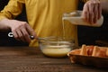 Pouring milk in a bowl with eggs Royalty Free Stock Photo