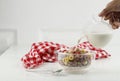 Pouring Milk into the Bowl with Froot Loops Colorful Cereal. Kids Breakfast Concept, White Background Royalty Free Stock Photo