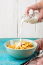 Pouring milk into a bowl of oatmeal. Royalty Free Stock Photo