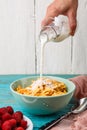 Pouring milk into a bowl of oatmeal. Royalty Free Stock Photo