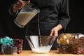 Pouring milk into the breakfast, freezing in motion. Cooking breakfast cereals, granules, breakfast cereals, cereals, berries of Royalty Free Stock Photo