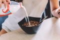 pouring milk in a cereal bowl Royalty Free Stock Photo