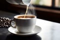 Pouring milk in coffee streaming in white cup of hot aroma cappuccino espresso latte steam smoke on table morning Royalty Free Stock Photo