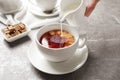 Pouring milk into cup of black tea Royalty Free Stock Photo