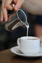 Pouring Milk into a Cup of Energizing Morning Coffee Royalty Free Stock Photo