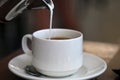 Pouring Milk into a Cup of Energizing Morning Coffee Royalty Free Stock Photo