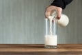 Pouring milk into a glass Royalty Free Stock Photo