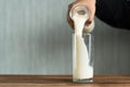 Pouring milk into a glass Royalty Free Stock Photo