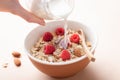 Pouring milk in oat muesli Royalty Free Stock Photo