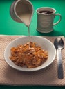 pouring milk onto breakfast cerial Royalty Free Stock Photo