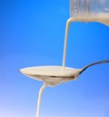Pouring milk to the spoon Royalty Free Stock Photo