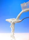 Pouring milk to the spoon Royalty Free Stock Photo