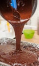 Pouring mixture of chocolate eggs and flour Royalty Free Stock Photo