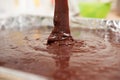 Pouring mixture of chocolate eggs and flour Royalty Free Stock Photo