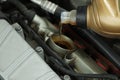Pouring motor oil into car engine at automobile repair shop, closeup Royalty Free Stock Photo