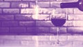 Pouring natural wine into a glass against a brick wall background,an alcoholic drink,close-up. Royalty Free Stock Photo